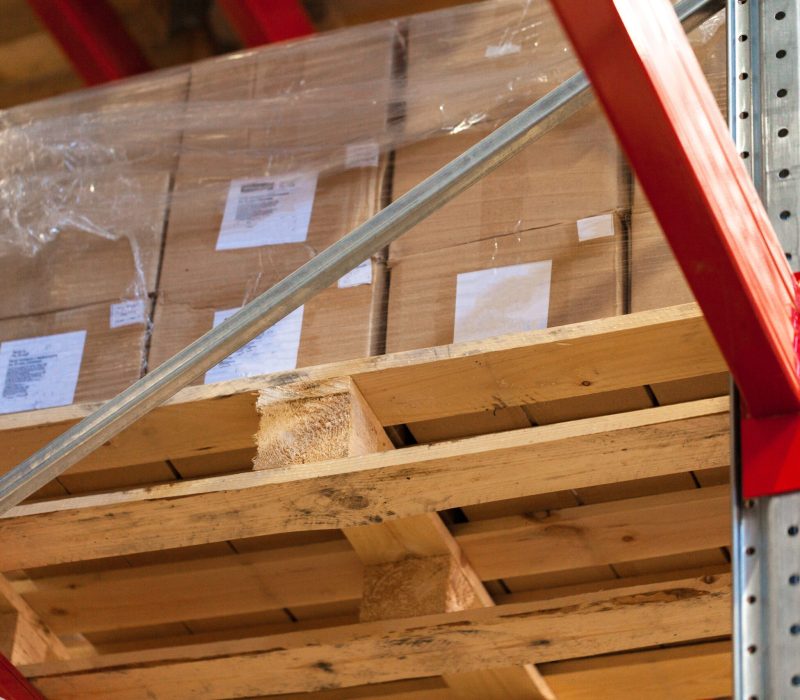 Modern warehouse shelves with pile of cardboard boxes